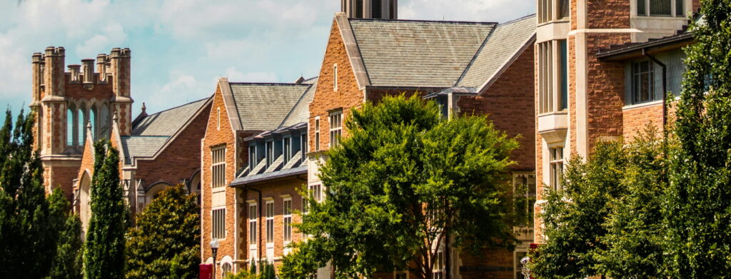 Collegiate Gothic style stone buildings with gabled roofs on a university campus
